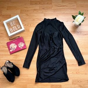 Body con high neck black dress with open chest for cute demensional look.